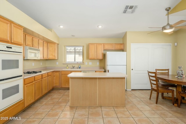 9446 E Olla Ave, Mesa, AZ 85212 - kitchen with white appliances, a center island, visible vents, a sink, and light brown cabinetry