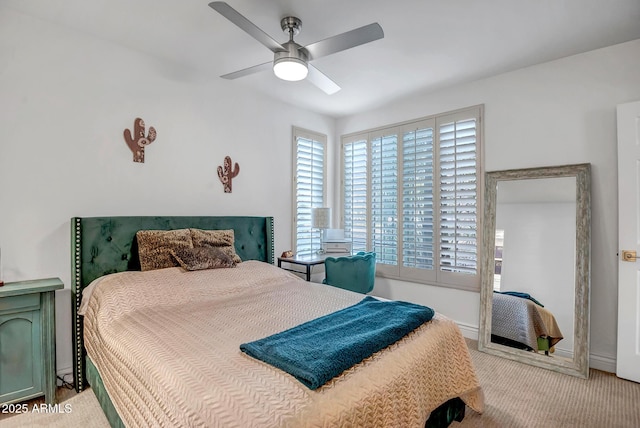 carpeted bedroom with baseboards and ceiling fan