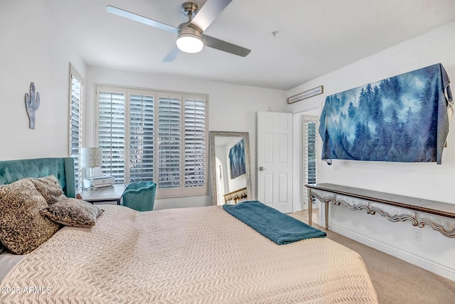 bedroom featuring a ceiling fan and carpet