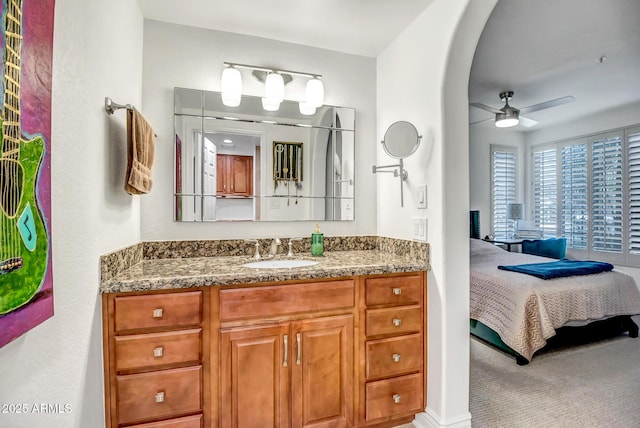 bathroom with vanity, ensuite bathroom, and a ceiling fan
