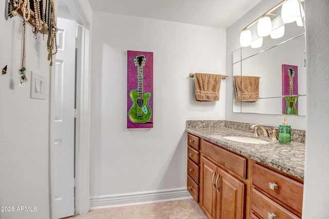 bathroom featuring tile patterned floors, baseboards, and vanity