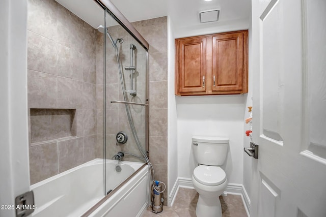 full bathroom with baseboards, tile patterned flooring, toilet, and shower / bath combination with glass door