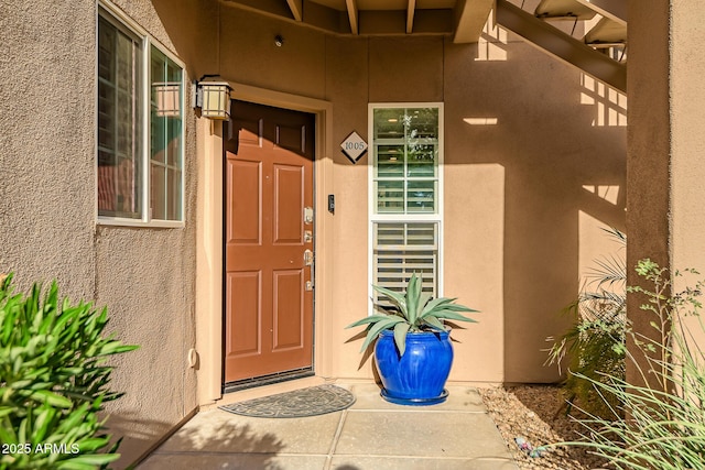 doorway to property with stucco siding