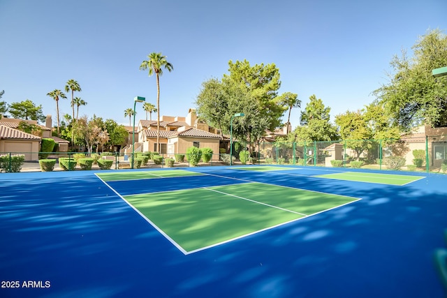 view of tennis court with fence and community basketball court