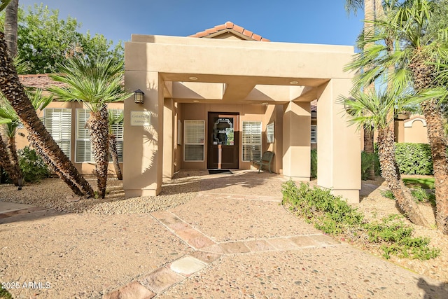 entrance to property with stucco siding