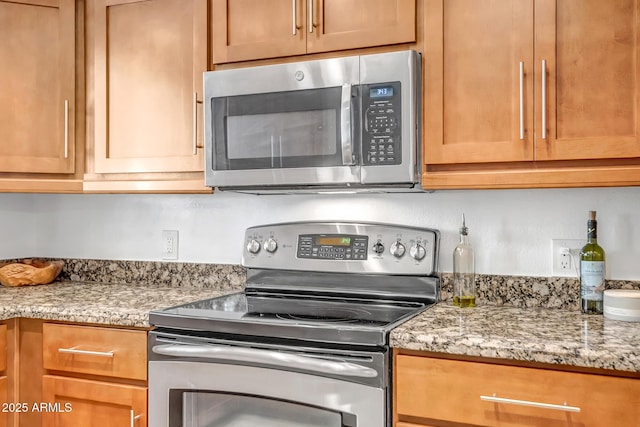 kitchen with stainless steel appliances and light stone countertops