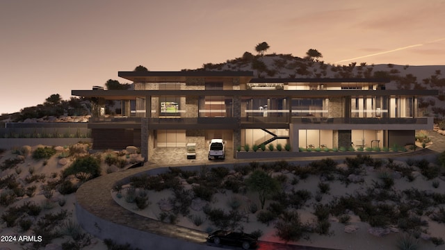 back house at dusk with a balcony