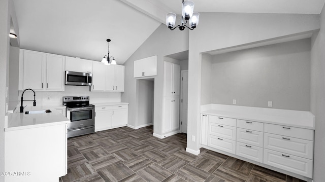 kitchen with a sink, lofted ceiling with beams, a notable chandelier, stainless steel appliances, and white cabinetry