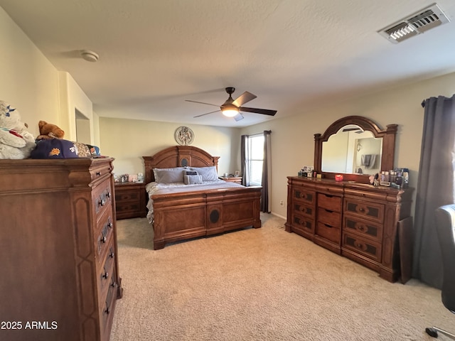 bedroom with ceiling fan and light colored carpet