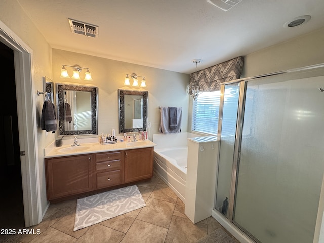 bathroom with tile patterned floors, shower with separate bathtub, and vanity