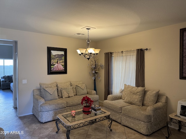 living room featuring a notable chandelier and light tile patterned floors