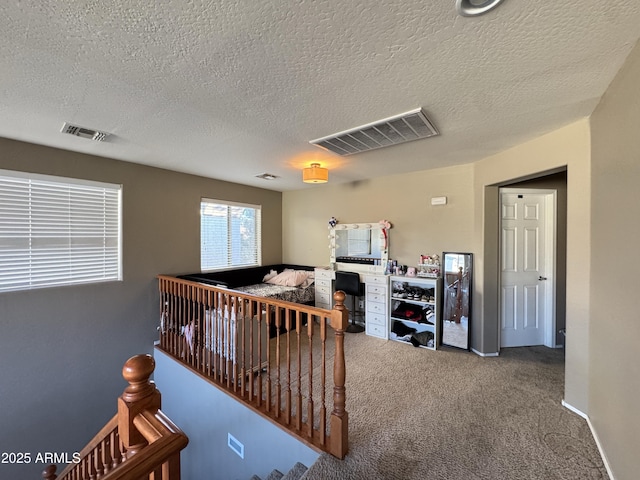 bedroom featuring a textured ceiling and carpet