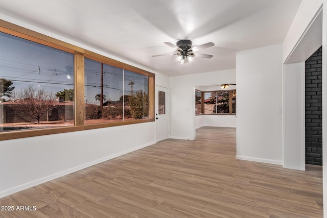 unfurnished room with light hardwood / wood-style floors and ceiling fan