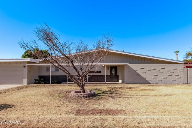 single story home with a garage and a front yard