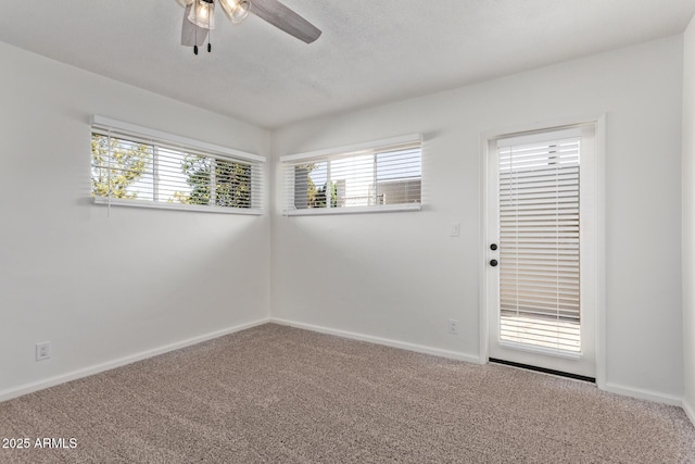 spare room featuring a textured ceiling, ceiling fan, and carpet flooring