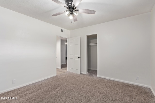 unfurnished bedroom with carpet flooring, ceiling fan, and a closet