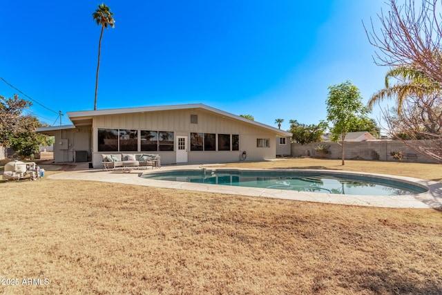 view of pool with a patio and a lawn