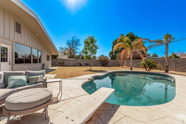 view of swimming pool featuring a diving board and a patio area