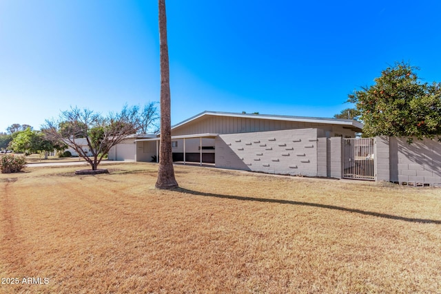 back of property featuring a yard