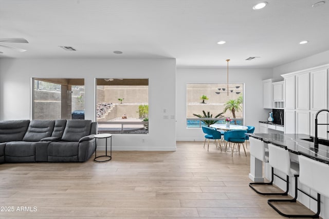 2722 W Hiddenview Dr, Phoenix, AZ 85045 - living area featuring recessed lighting, ceiling fan, light wood-style floors, and baseboards