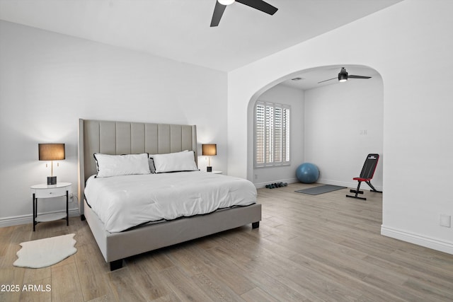 2722 W Hiddenview Dr, Phoenix, AZ 85045 - bedroom featuring wood finished floors, baseboards, arched walkways, and a ceiling fan