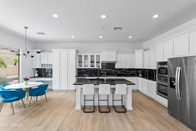 2722 W Hiddenview Dr, Phoenix, AZ 85045 - kitchen featuring stainless steel appliances, dark countertops, recessed lighting, decorative backsplash, and white cabinets