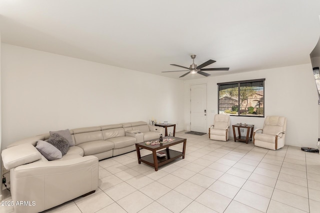 living area with light tile patterned floors and a ceiling fan