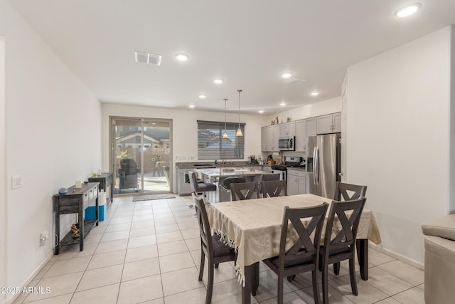 dining area featuring light tile patterned flooring, recessed lighting, visible vents, and baseboards