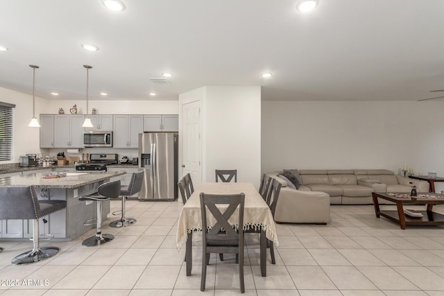 dining room featuring light tile patterned flooring, recessed lighting, and visible vents