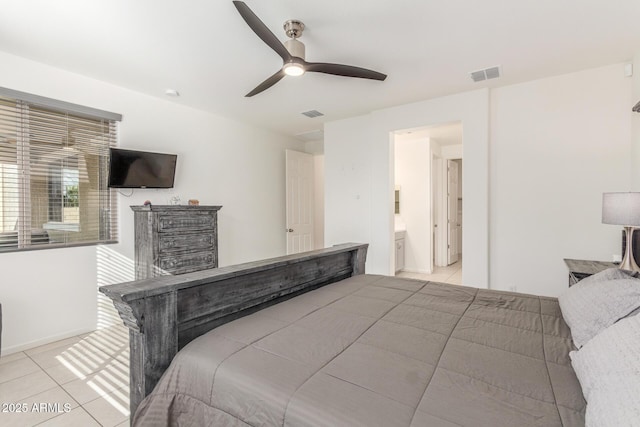 bedroom featuring light tile patterned flooring, visible vents, ensuite bathroom, and a ceiling fan