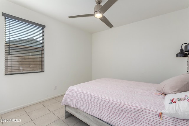 bedroom featuring light tile patterned flooring, baseboards, and ceiling fan