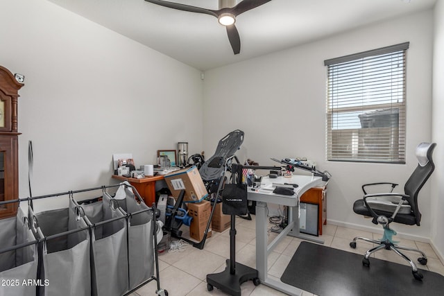 tiled office space featuring baseboards and ceiling fan