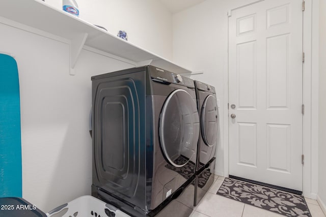 washroom with light tile patterned flooring, laundry area, and independent washer and dryer