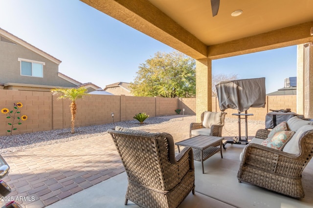 view of patio featuring an outdoor living space and a fenced backyard