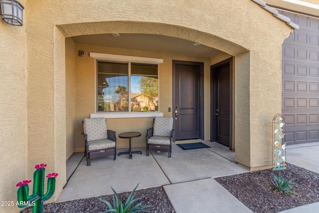 doorway to property featuring stucco siding