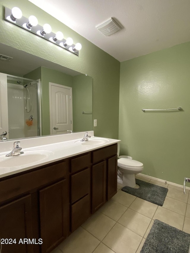 bathroom featuring tile patterned floors, walk in shower, toilet, and vanity