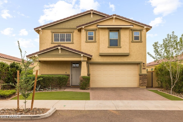 craftsman-style house with stucco siding, driveway, a garage, and a tiled roof