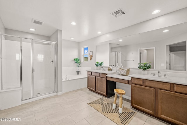 full bath featuring vanity, a shower stall, a bath, and recessed lighting