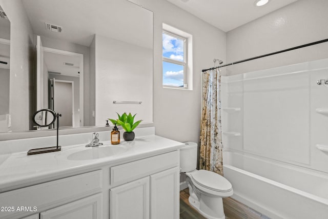 full bathroom with toilet, wood finished floors, vanity, and shower / bath combo