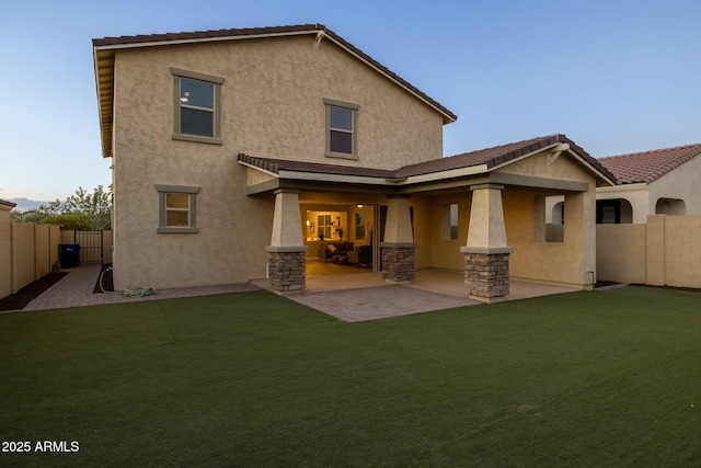 back of house featuring stucco siding, a fenced backyard, and a patio area
