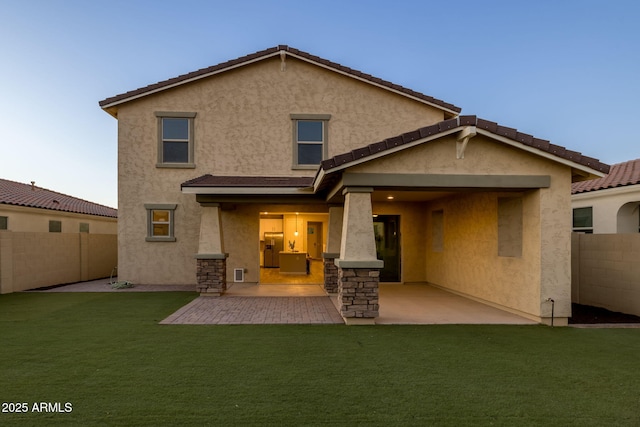 rear view of property featuring stucco siding and a patio area