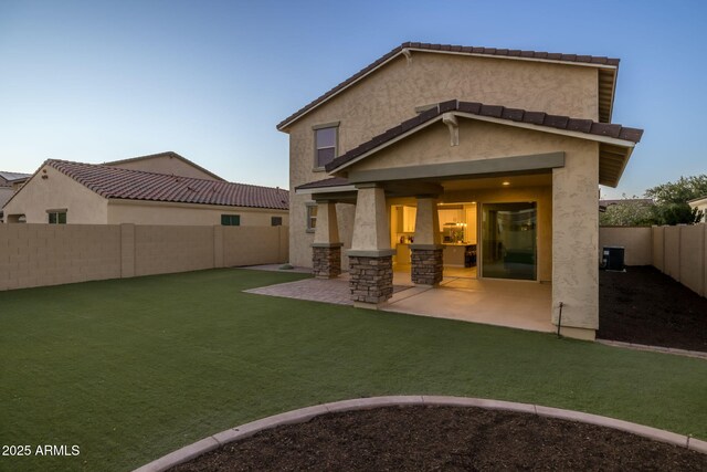 rear view of house with stucco siding and a patio area