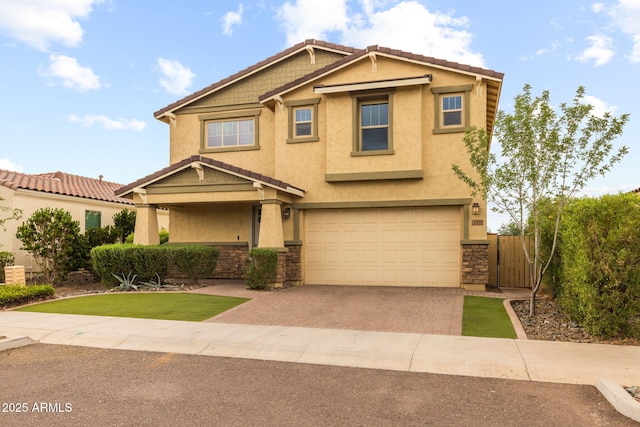 craftsman-style house with stucco siding, a garage, driveway, and stone siding