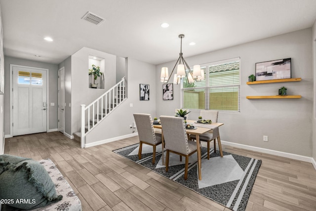 dining room with stairs, baseboards, light wood-style flooring, a chandelier, and recessed lighting