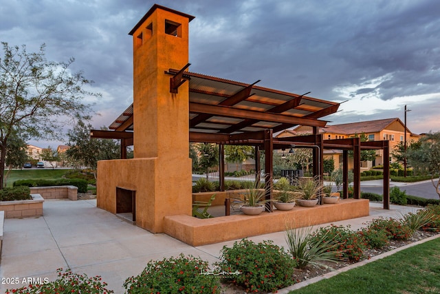 view of community featuring a pergola and a patio area