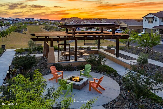 view of patio featuring an outdoor fire pit and a residential view
