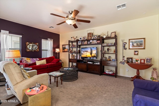 carpeted living area featuring a ceiling fan and visible vents