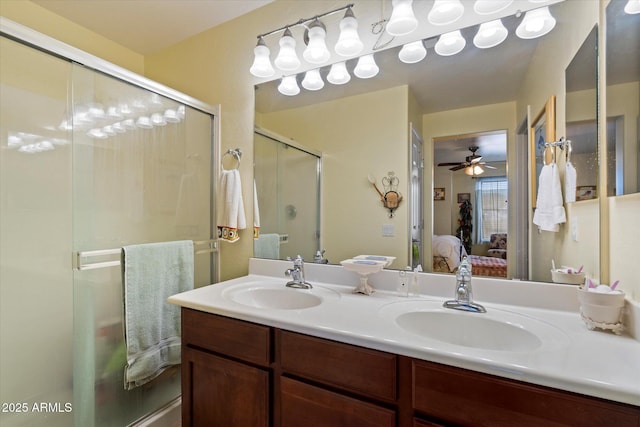 ensuite bathroom with double vanity, a sink, connected bathroom, and a stall shower