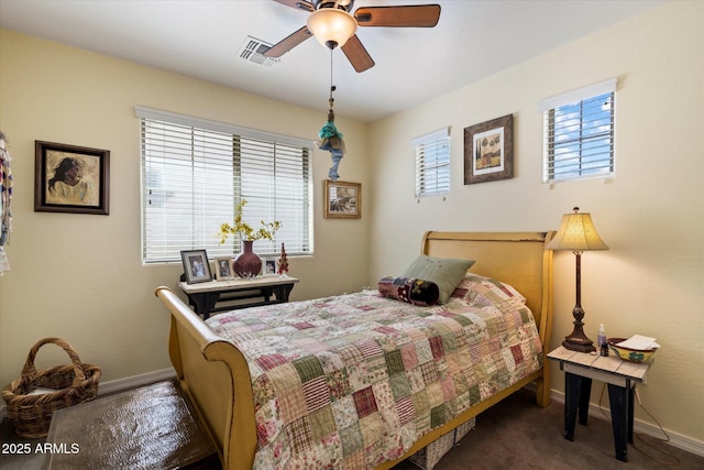 bedroom featuring baseboards, a ceiling fan, carpet flooring, and visible vents