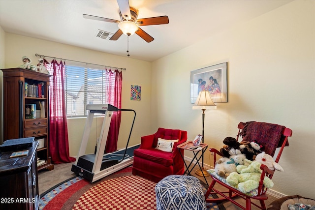 interior space with ceiling fan, visible vents, and carpet